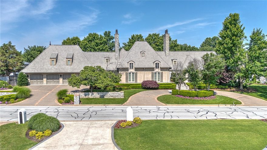 Welcome to an exquisite and timeless estate tucked away on over half an acre in NWA's exclusive, gated Pinnacle Country Club boasting sweeping views of the 10th fairway!  Enjoy a short golf cart ride to the clubhouse and driving range from this impeccably maintained property, featuring a circular front drive and a spacious 4-car garage. Masterfully designed, this partially furnished home offers a predominantly main-level layout with multiple living and entertaining areas. The grand great room is anchored by a fireplace at each end, a fully equipped gourmet kitchen offers both function and flair, two private studies provide dedicated workspace for everyone while a spacious and elegant sunroom creates a beautiful dining setting opening to the English gardens and patio. The luxurious primary retreat features a private fitness room, a boutique-style walk-in closet, and a spa-inspired en suite bath.  Upstairs, a spacious game room and media room make this home an entertainer’s dream. Pinnacle perfection at its finest!