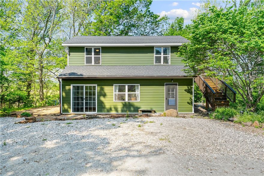 Escape to this peaceful 8± acre Ozarks retreat offering space, flexibility, and income potential. The main home (1,800 sq ft) features 2 bedrooms and 2 baths, with a bedroom, bath, and living room on the main level, plus an upper level with a second bedroom/bath, living area, kitchen, and two decks perfect for relaxing and enjoying nature.

Two additional dwellings(not included in sq ft) include a cozy 294 sq ft cottage with 1 bed, 1 bath, kitchen, and wrap-around deck, and a 396 sq ft tiny home offering 2 bedrooms, a bright sunroom, and a greywater system. Ideal for rental income, guests, or multi-generational living.

Stay connected with OzarksGo high-speed internet. Conveniently located near the White River, Bunch Park, and area schools. Enjoy quiet mornings, scenic views, and true country living.