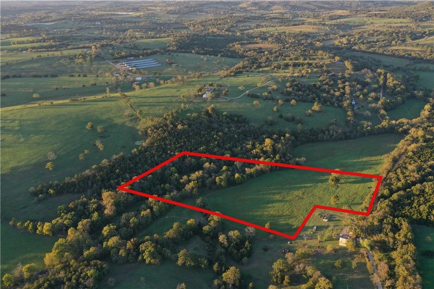 Tract  B A beautiful 18.38 acre mix of pasture and mature timber, located just off the Hwy 221 North in Berryville, Arkansas. This peaceful property is tucked away only 1.4 miles down a well maintained gravel road, offering privacy without sacrificing accessibility. A seasonal Creek meanders through the land, adding charm and character, while the surrounding woods provide natural beauty, shade and a haven for local wildlife. A rustic old cabin sets along the creek and needs to be remodeled. Deed Restrictions include No mobile homes over 15 years old, No commercial chicken or Hog houses, No junk cars or piles or trash. This property is part of Carroll County, Ar. parcel # 001-05272-001  Red lines on puicture are estimated.