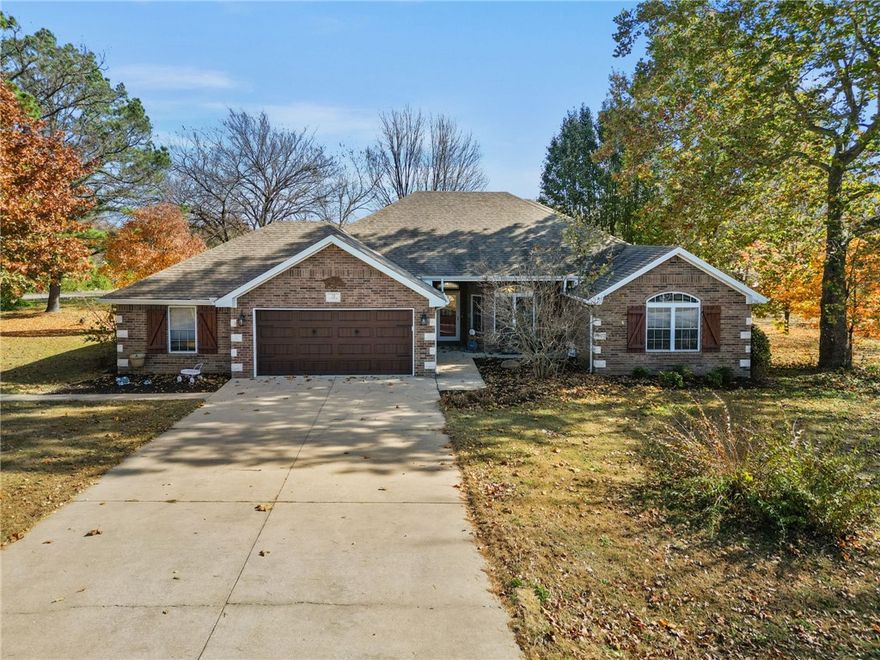 This brick home sits on two lots and offers 3 bedrooms, 2.5 baths, with a second living area that can easily serve as a 4th bedroom or rec room. The large living room features a gas log fireplace, while the kitchen shines with granite counters, breakfast bar, bay window, Italian ceramic tile, and updated appliances. Spacious primary bedroom! Additional features include hardwood floors, oversized laundry/utility room, and the home is wired for surround sound. Enjoy a 2-car attached garage plus a detached 2-car garage with workshop, gutter guards, and a relaxing deck. Refrigerator can convey with accepted offer. Conveniently located near Bella Vista’s lakes, trails, and golf courses, and just a short drive to Downtown Bentonville.