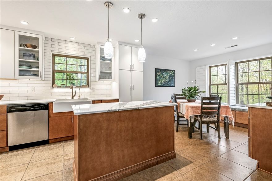 Well-Appointed home with a transformed kitchen boasts modern cabinets, quartz countertops, double-ovens, stainless appliances (including fridge), coffee bar, under-counter microwave, farmhouse sink, and reverse osmosis water filter, and new lighting fixtures. Home also features a basement office, ideal for remote work. Wood floors, plantation blinds, and fresh paint in most rooms. Washer, dryer, and whole-house water softener included. Enjoy high-speed Starlink internet for only $120 a month, large .39 spacious yard with lush trees, and garden beds. The roof was replaced in Aug. 2023! Near Lake Windsor with access to a boat dock in the highly sought-after Bella Vista community!  Bella Vista amenities include multiple lakes, golf courses, tennis, pickleball, pools, and clubhouses. Explore the world-famous trails in the Mountain Bike Capital of the World. Quick access to new I-49 and just 20 minutes to Bentonville or Rogers!