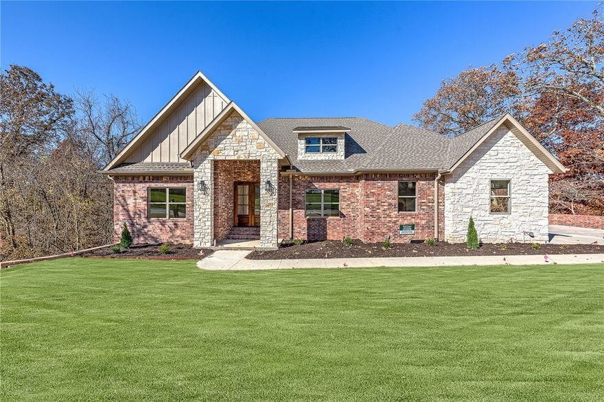 This exquisite new construction luxury estate is a true masterpiece, offering the perfect blend of modern elegance and timeless sophistication. Nestled in The Bluffs, this home boasts an array of extraordinary features that will leave you breathless. As you step through the grand entrance, you'll immediately be captivated by the spacious open floor plan that seamlessly integrates the living spaces, creating an inviting and harmonious flow throughout. Towering, spectacular windows adorn every room, bathing the interior in an abundance of natural light and offering breathtaking views. The chef's kitchen is a masterpiece, featuring an oversized island, that serves as the heart of the home.  The adjacent butler's pantry is perfect for keeping everything organized and hidden away, allowing you to maintain a clean and clutter-free environment.The luxurious living room is the epitome of comfort and style, complete with a gas linear fireplace that exudes warmth and ambiance.