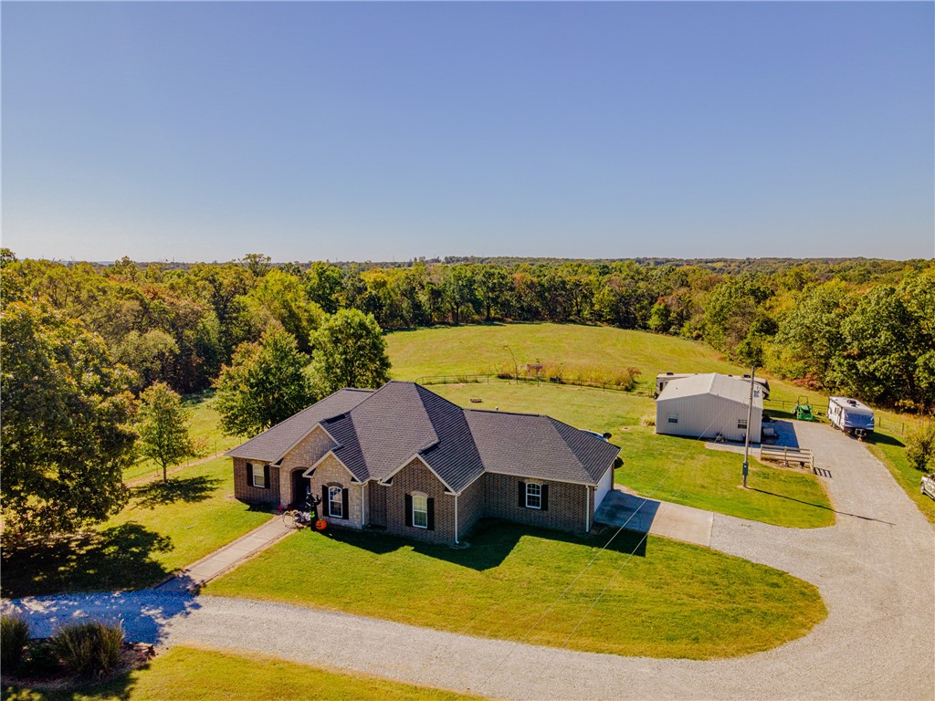 Looking for a retreat that you can call home? This is it! The long private drive leads you back to this all brick,1854 sq ft home situated on 40 amazing acres. Front 20ac are leased for hay & the back 20 have trails & deer stands! Entire property is fenced & cross fenced so bring the livestock. The home has 3bed/2.5bath, true hardwood floors, crown molding, & gas log fireplace in the living room. The kitchen features granite countertops, stainless steel appliances, & crown molding in main areas. The spacious master suite features a large bathroom w/double vanity, whirlpool tub, separate shower, walk-in closet and your own private covered porch to enjoy that morning cup of coffee. The secondary bedrooms are separated by a Jack & Jill bath, w/an extra half bath in the hall. Walk outside to a large stone patio shaded by a pergola, a relaxing 24’ above-ground pool & a 30x40 shop for your toys, complete w/220 power & 50 Amp RV Plug. Tired of the kids? Stick them in the 500 sq ft 1BR/1BA apartment, complete w/kitchen.