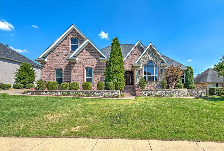 Amazing home in Shadow Valley with picturesque panoramic views of Shadow Valley Lake, Holes 3 & 4 on the beautiful SV Golf Course. Must-see home in one of the most sought after location in NWA. When you visit head upstairs, stop by the bar with built in wine fridge, pass through the theatre and then head to the covered balcony and get an even better view of the golf course and the annual AMP 4th of July firework display! This home also has 4 bedrooms, 3.5 baths, a giant office, ideal to work from home, another office upstairs for dual careers. Huge media/theater room with stadium seating and 115” movie screen.  Offers 4 car garage, gunite swimming pool with built in hot tub. Newer roof, appliances, and 2 complete HVAC systems. The detached 2 car garage is heated and cooled, has a workshop area with built in cabinets and closets.  Large flex room upstairs perfect for office, kids place, workout room, so many options!! Custom made iron fence with brick base surrounding the pool area. Tennis membership included!