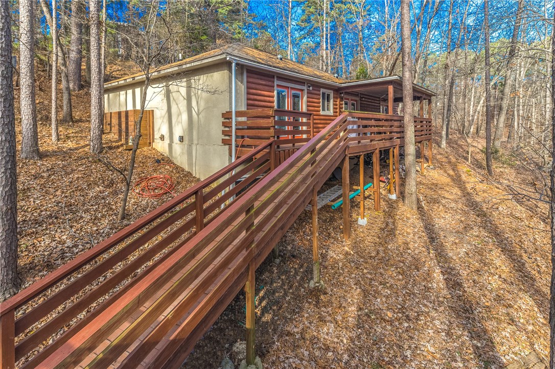 Great secluded home on almost 2 acres! Would be a perfect getaway place. Only 20 minutes away from Beaver Lake, Table Rock, Black Bass, Leatherwood Lake, Lake Eureka, Kings River, & White River. Could be a 4 bedroom or 3 with an office or game room. Nice open living area to the kitchen. Pool table conveys. Kitchen has plenty of cabinet space, granite counters, stainless steel appliances, & beautiful wood carved island is negotiable. Master has a skylight, access to back deck, dual vanity, & walk-in closet. Sit out and relax in the hot tub. 8" concrete walls outside and 3 1/2 insulated walls inside. Come see this wonderful property!