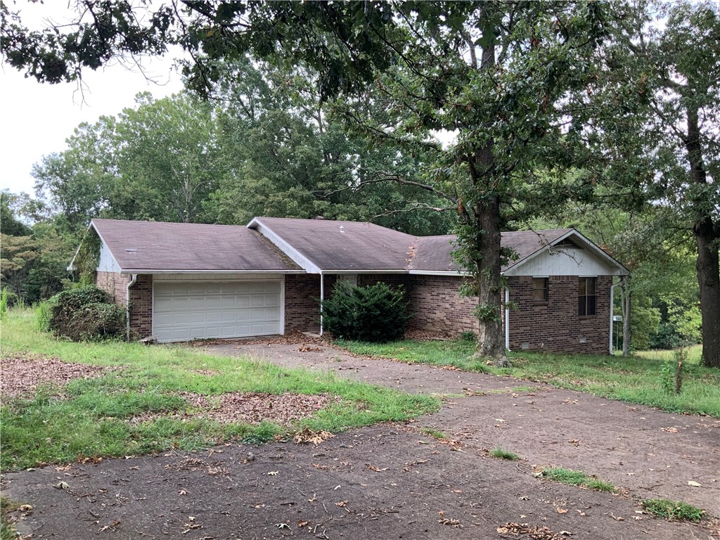 Don't miss the potential in this project property! Well constructed, 1365 sqft 2br/2ba home with open living area, nice closets, oversized 2 car attached garage, and wood stove. The yard is 1.17 acres of all useable ground with large shade trees, nice back deck overlooking the view. Great location for Hwy 412 access and all necessities. Newer HVAC. Great opportunity for your personal home or investment!