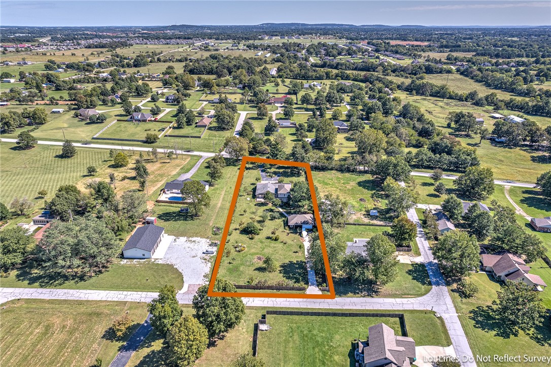 This home is a RARE find!!! Looking for over 3800 sq feet, a large SHOP, Solar Panels (PAID FOR), an In- law apartment or investment producing opportunity with a private entrance/exit, and 1.41 acres that is flat and buildable with lots of options. This home sits is almost entirely landscaped with Arkansas Native plants. It has been certified as a wildlife habitat and has hundreds of locally adapted trees, plants, fruit producing trees! The apartment (in law space, rental, STR, etc) boasts of a full living space, full bedroom, full bathroom, and full kitchen. The home has a huge mud room/ storage space, a non conforming additional office space/room, a bonus space and full bedroom upstairs, two living room sitting spaces, two dining spaces, and so much more! Check out this rare opportunity to find a home and land and make it your own. You could buy this and have some family or friends build on that back portion! Most of home was fully redone 2005.