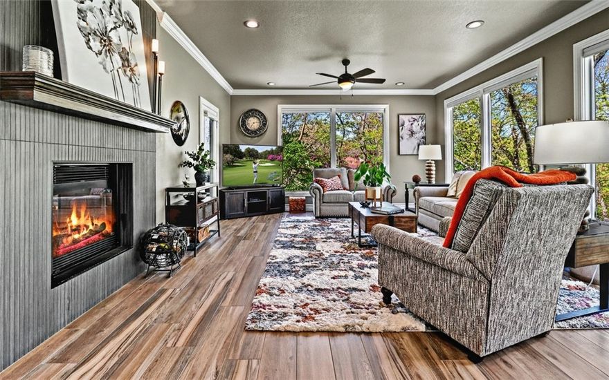 Quality-built with timeless OAK construction and a recently updated interior, this home blends craftsmanship with modern comfort. The open kitchen features a large island, pantry, and oversized appliance cabinet, flowing seamlessly into the hearth room with floor-to-ceiling windows for abundant natural light. Ideal for entertaining, enjoy a formal dining room and spacious living area, plus a private office just off the kitchen. The large primary suite offers a tray ceiling with rope lighting, and a bath with double sinks, vanity area, and a walk-in tower shower. A half bath and laundry are conveniently located nearby. The lower level includes spacious bedrooms, a great room with patio access, and a hobby room with exterior doors. Relax on the updated composite deck. Conveniently located near I-49, trails, golf, tennis, and pools. See attached amenities and updates list.