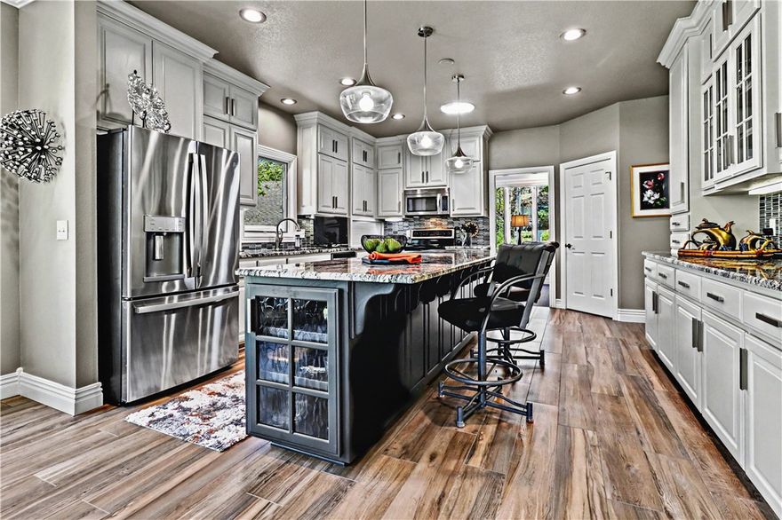 Quality-built with timeless OAK construction and a recently updated interior, this home blends craftsmanship with modern comfort. The open kitchen features a large island, pantry, and oversized appliance cabinet, flowing seamlessly into the hearth room with floor-to-ceiling windows for abundant natural light. Ideal for entertaining, enjoy a formal dining room and spacious living area, plus a private office just off the kitchen. The large primary suite offers a tray ceiling with rope lighting, and a bath with double sinks, vanity area, and a walk-in tower shower. A half bath and laundry are conveniently located nearby. The lower level includes spacious bedrooms, a great room with patio access, and a hobby room with exterior doors. Relax on the updated composite deck. Conveniently located near I-49, trails, golf, tennis, and pools. See attached amenities and updates list.