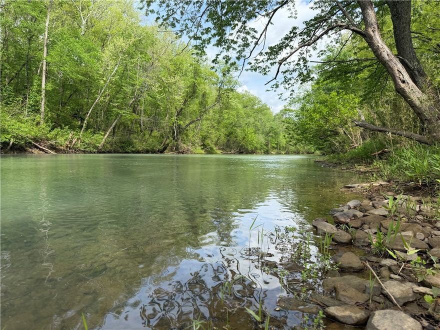 Escape to the White River and experience true Ozark freedom. This 24+ acre recreational retreat near Elkins—just 30 minutes from Fayetteville—offers ~700 feet of private river frontage with direct access to the water’s edge. Spend your days floating calm waters, fishing for smallmouth and largemouth, or unwinding in wooded privacy with scenic river views. Designed for easy enjoyment, the property features level terrain, two cleared build sites, marked boundaries, and 2WD-friendly access (under 2 miles of dirt road). Electric and fiber optic are available at the road; well and septic needed. No restrictions allow you to create the getaway you want—RV weekends, camping, or a future cabin. Abundant wildlife adds to the experience. Located in the 100-year floodplain; elevated construction may be preferred. Private. Usable. Ready to enjoy.