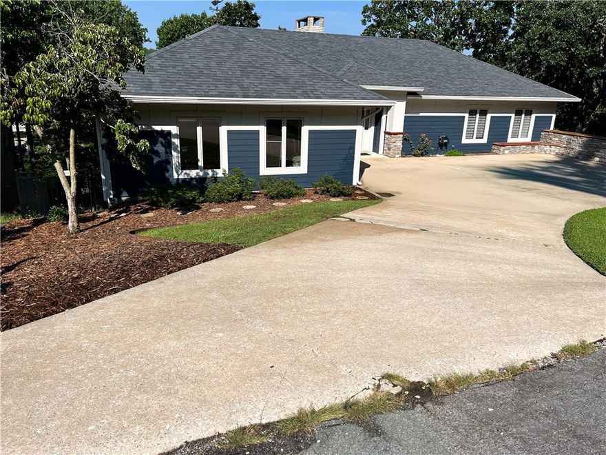 Experience resort-style living with this exceptional lakefront home on a rare DOUBLE lot on Lake Windsor! Thoughtfully updated and move-in ready, it blends timeless comfort with modern luxury, and rare drive-to-the-water convenience! The lake-level backyard allows you to drive a car or golf cart directly to the shoreline, a true Bella Vista luxury. Enjoy mornings on the deck, afternoons by your private pool, and evenings watching sunsets shimmer across the lake. Inside, fresh updates include new carpet, skylights, and new paint, creating a bright,inviting atmosphere. The open-concept living area features soaring ceilings, natural light, and panoramic lake views. A well-appointed kitchen with premium finishes connects seamlessly to dining and entertaining areas. Retreat to spacious bedrooms and spa-inspired baths, or unwind outdoors surrounded by mature trees and manicured landscaping. Minutes from I-49, downtown Bentonville and bike park, this immaculate home perfectly combines lake access, luxury, and convenience.