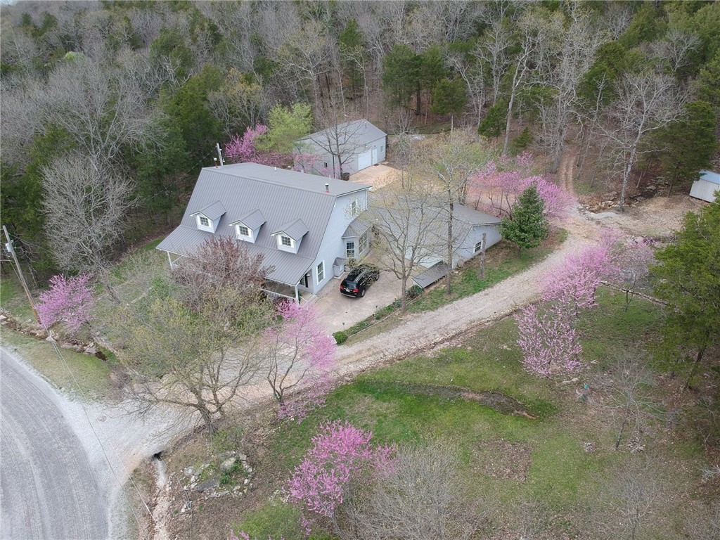 Discover the perfect blend of space, comfort, and versatility in this beautiful 4 bedroom, 3.5 bathroom property, nestled on 4 spacious lots across 2.18 acres. Offering a unique opportunity with multiple workshops, ideal for hobbyists or those needing ample storage. One workshop is already prepared to be a cozy 768 sq ft mother-in-law suite, offering potential for extended family living or a guest retreat. The home 2,672 sq ft features a thoughtful layout, with a spacious living area and kitchen. The bedrooms are generously sized, with the primary suite boasting an en-suite bathroom for added privacy.
Outside, the expansive lots provide endless possibilities, further development. Whether youāre looking for a quiet retreat or a place with room to grow, this property offers it all.
Enjoy the tranquility of Holiday Island living, with the added convenience of nearby amenities, including golf courses, lakes, and shopping, only 15mins+/- to Eureka Springs.