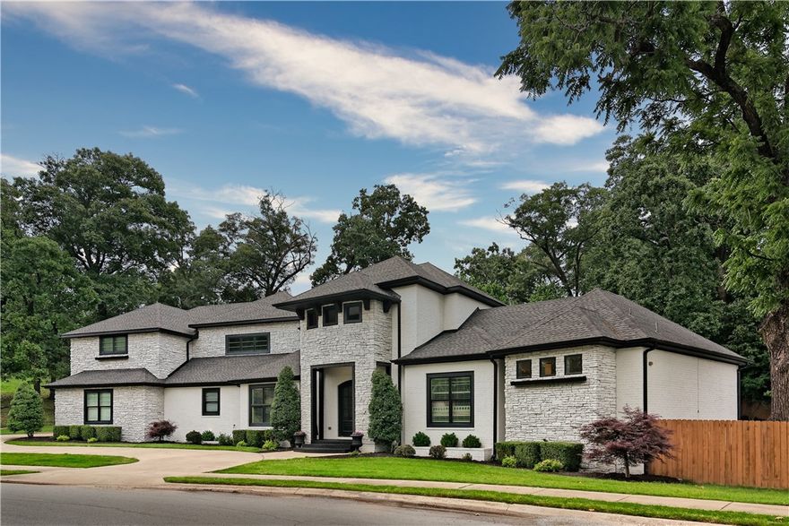 Custom designed home by John Starnes Architecture & Black Door Interior Designs with custom aqua crete pool and custom pool house.  Home has been completely updated inside and out including porcelain tile flooring, carpets, kitchen, bathrooms, quartz counter tops, lights, decks and landscaping.  This is truly a one-of-a-kind home on 3/4 of an acre in Bentonville school district. Custom features of home include extensive storage, large closets throughout the home, custom built-ins, large mud room, soaring ceilings, luxury bathroom, designer features and colors.  Pool is heated, self-cleaning with tanning ledge and custom lights. Pool house has kitchenette, full bath, tankless water heater, mini split and separate deck. Landscaping include outdoor living space, decks, retaining wall, firepit and mature trees. Garage has two electric car charging ports. (Heated sq. ft. includes approximately 336 sq. ft. pool house.  Pool house bedroom and bathroom included in total bedrooms and bathrooms.)