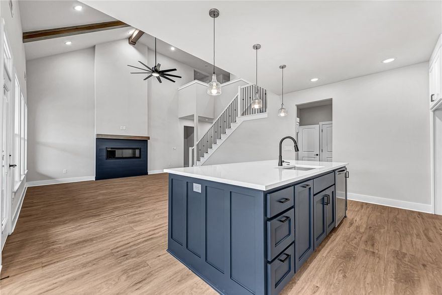 This beautiful new home sits directly across from Gamble Elementary and offers a highly functional layout. The main level features a primary suite with a full bath, a second bedroom, an office/exercise room, and an additional full bath. Upstairs, you’ll find two more bedrooms, a full bath, and a spacious theater/game room. Thoughtful upgrades include soaring ceilings with banister railings, quartz countertops, tiled showers, an electric fireplace, and a gas line for outdoor grilling. The open kitchen is appointed with custom cabinetry, a large walk-in pantry, and luxury vinyl flooring throughout the main level. The garage also includes an EV charging port. Ideally situated within walking distance of both Gamble Elementary and Bentonville West High School, the home provides quick access to I-49 for convenient trips to downtown Bentonville and the Walmart offices. $10,000 Seller credit toward closing costs/rate buy-down!