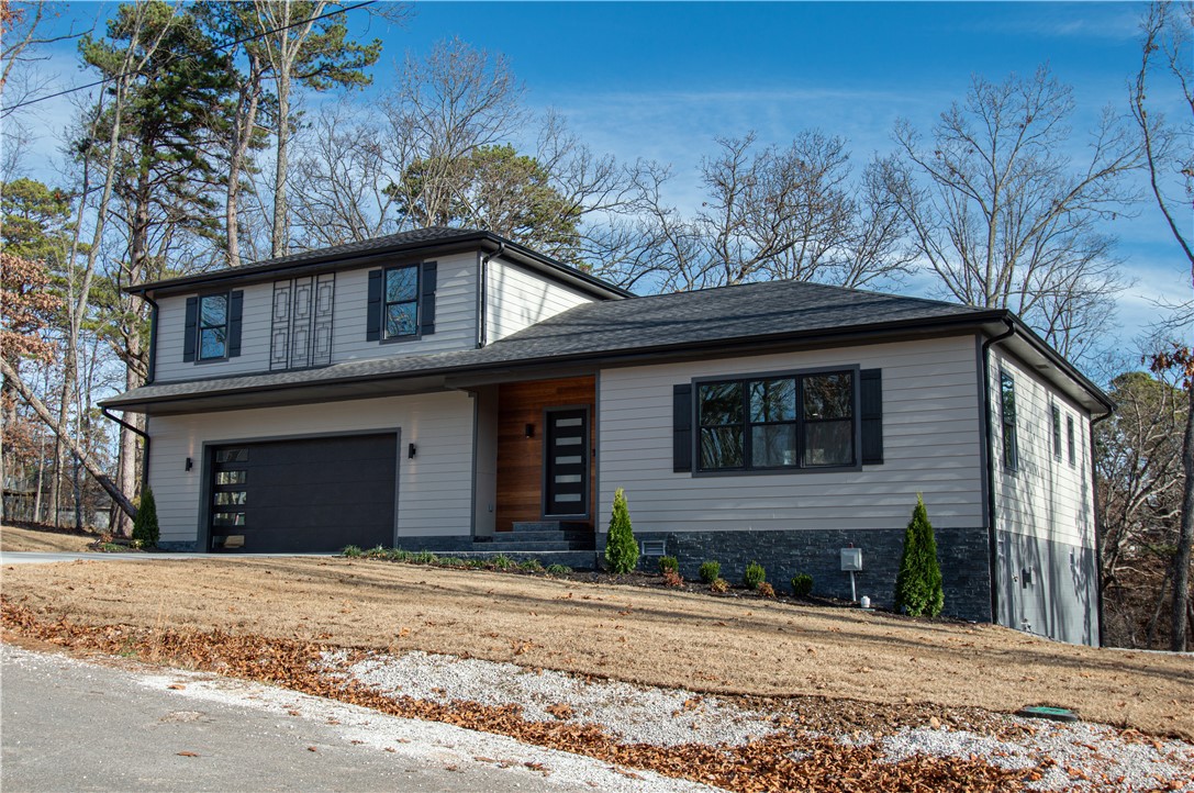 Spectacular contemporary home built with beauty and functionality. Large open concept kitchen and living room with beautiful ledgestone electric fireplace. Floor to ceiling custom cabinets provide immense storage, while exquisite patterns of the Mona Lisa granite capture your imagination. Master bedroom is on the first level with large walk in closet, beautiful walk in shower, and free standing tub. Master bedroom and kitchen overlook a spacious deck with a peaceful scenery of wooded valley. Under the large deck is an additional 520 sqft of covered area that will stay dry thanks to the installation of Dexerdry weatherstripping and composite decking. Adjoining this area is access to 735 sqft basement workshop and a climate controlled oversized crawl space with average 7 ft ceiling height. The second level has a second master suite with it's own bathroom and large walk in closet. A large bonus room and extra bathroom separates the suite from 2 additional generous sized bedrooms with walk in closets.