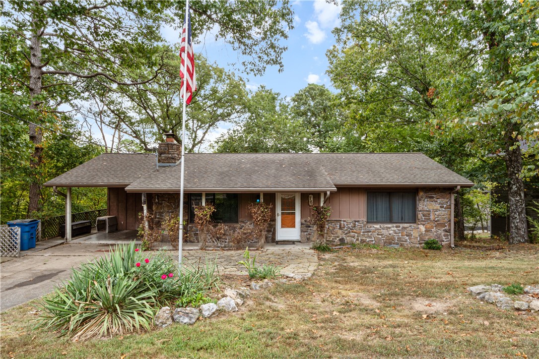 This rustic rock house has so much potential to offer! The home has a beautiful wood burning fireplace with a rock face running from floor to ceiling. Windows throughout the house, as well as the rear sliding glass doors, have recently been replaced with high end energy efficient windows and doors! The house has a 3rd bedroom that could have its own private entrance (the entrance has temporarily been closed off), or the 3rd room could be an office, bonus room, or a endless number of options to meet a buyer's needs. The main bathroom has a gorgeous clawfoot tub with a shower set up as well. Both the front porch and the back deck are extra large spaces to be able to entertain outside, or to take in the beauty of the outdoors that surrounds the XL 0.41 acre lot. A new HVAC system was installed appropriately 5 years ago. There is loads of potential in this well built, gem located just west of the Back 40 trail loop!