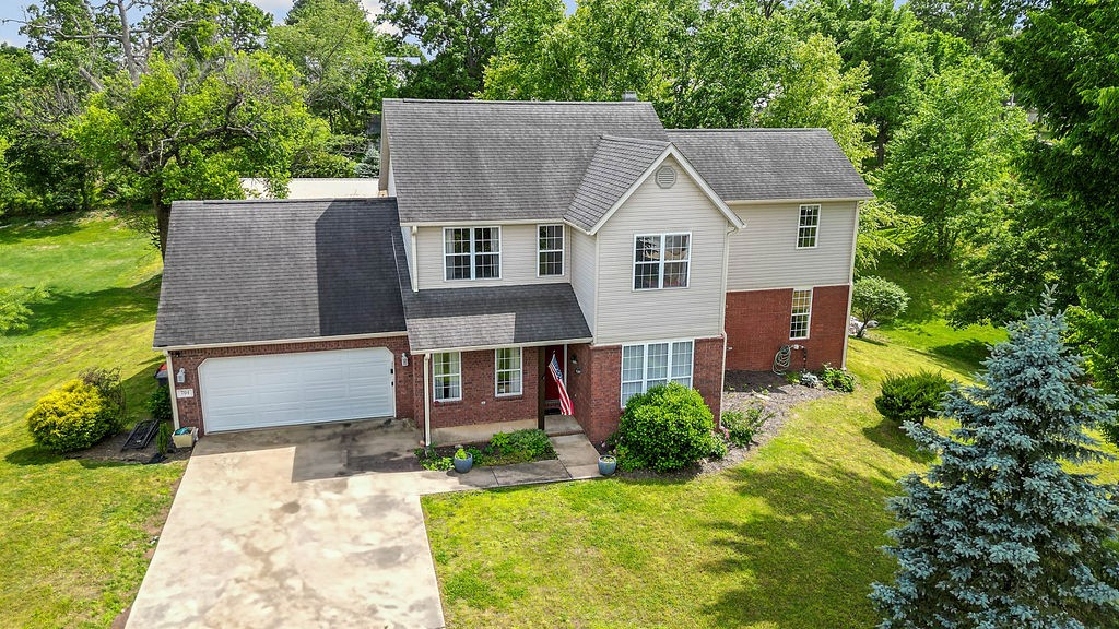 Situated on a 0.64-acre lot, this 3-bed, 3-bath home offers generous space & flexibility. The updated kitchen, complete with granite countertops & ample storage, flows into a formal dining room & hearth room, perfect for entertaining. One bedroom and full bath on main level provides privacy for guests or multi-generational living. Enjoy the cozy sunroom or step out to a patio with a pergola, built-in electric hookup, bar seating, & grilling area. Off the sunroom, a large family room offers the ideal gathering space. Upstairs, the expansive primary suite includes two closets, a bonus room & a beautifully updated ensuite with a walk-in tiled shower, soaking tub & dual vanity. The landing at the top of the stairs is perfect for a second living room or creative space & separates the primary suite from an additional bedroom & full bath. The detached 720 sq ft shop is perfect for a workshop or extra storage. One owner. Bentonville schools. This home offers comfort, flexibility, & room to grow, don't miss out!