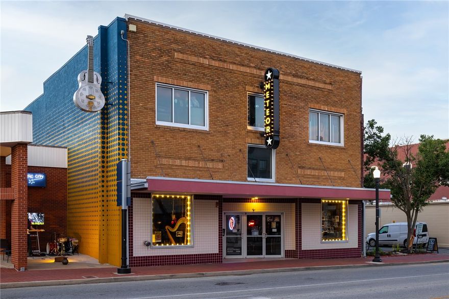 Investment opportunity! Don’t miss this once in a lifetime opportunity to own the iconic Plaza Theatre Building located one block from the thriving Downtown Bentonville Square & the Razorback Greenway Trail. The Arts & Market Districts…Crystal Bridges, Amazeum, The Momentary, 8th Street Market, new Walmart Corporate Headquarters…are just a short walk or bike ride away. The building is currently in use as a live entertainment/special events space with some retail. Development potential exists for restaurant or office space. Easy access to on-street parking & public parking garages in close proximity. Building is 7,882 square feet (main floor = 4902sf & mezzanine/second floor/third floors combined = 2980sf)  North side of building has alley access. Current tenant, Meteor Guitar Gallery, has a month-to-month lease in place, and the business is not for sale. Zoning is Downtown Core.