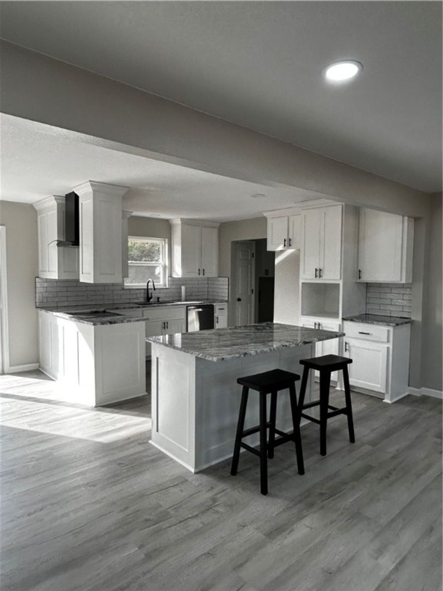 Fully Remodeled from the Studs Up! 
Welcome home to this beautifully renovated 3 bedroom, 2 bathroom property in the heart of Ozark, featuring 1,476 square feet of living space. Every detail has been thoughtfully updated, offering the feel of a brand-new home with modern finishes throughout. The kitchen boasts granite countertops, a subway tile backsplash, and updated cabinetry with built in pantry, while the home also features new, beautifully designed bathrooms. Major improvements include a new roof, HVAC system, and water heater, giving you peace of mind for years to come.

The open layout provides a bright, inviting space perfect for entertaining or everyday living. Outside, enjoy a spacious yard with plenty of room to relax, garden, or play. Conveniently located within walking distance to Ozark Jr. High and Upper Elementary, and less than one mile to Arkansas Tech University, plus close to shopping and everything Ozark has to offer, this move-in ready home is a rare find.

Schedule your showing today!