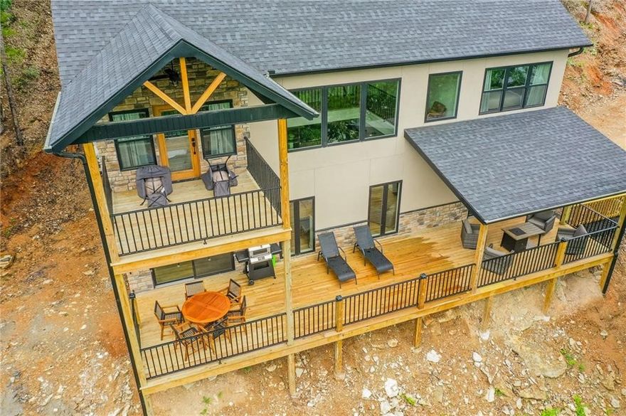 Experience lakefront living at its finest! This fully furnished home sits on Beaver Lake’s Clear Point Cove with stunning lake views and direct access to your own private beach (Corp of Engineers property). Walk just steps to swim, fish, kayak, paddle board, or unwind by the water. Turnkey and move-in ready, this property borders Hobbs State Park with access to miles of hiking and biking trails—perfect for nature lovers or STR investors. Inside, enjoy a beautifully appointed kitchen, a bar area with games, cozy fire pit, and a one-of-a-kind bunk room with three bunks and an indoor slide sure to delight the kids. The home features a primary suite, two additional guest suites (designed for STR use without closets), plus extra sleeping space in the downstairs bunk area and a full guest bath/laundry. With two expansive decks, an outdoor shower, fire pit, and all furnishings included, this property is ready for lake days, cozy nights, and unforgettable memories.