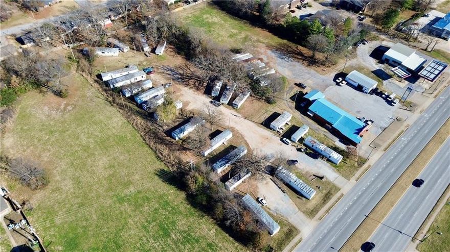 Prime development land with a Cash-Flowing Business! 2.37 acres with 200' of Hwy 412 frontage. Mobile home park generates 130K yearly. Zoned C-2.