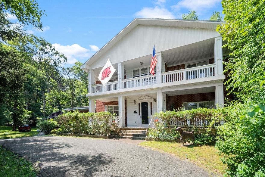 Calling all investors! Rare find right off 71 with a bike trail and fence currently being built right next to the property! Private driveway, hide away back porch, and two decks all on 2 acres. The garage/barn has tons of storage and upstairs can be converted into an apartment (plumbed for heat with water and gas connection readily available.) With two living areas in the main house let your imagination run free and create your dream now!