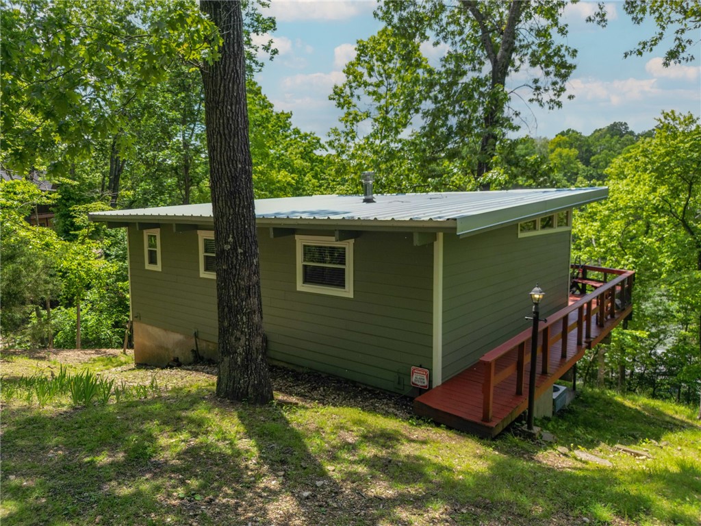 Hard to find lakefront cabin in the highly sought after Nelson Hollow cove with a deep water ledge spanning 175' of shoreline. Meticulously maintained home features all new windows, metal roof and exterior paint. The large main floor deck is perfect for those lazy lake days or that peaceful morning cup of coffee. A gentle sloping walkway with a new wooden bridge makes for easy access to the private self leveling boat dock that requires very little maintenance. 6000 lb boat lift conveys as well. Tranquility at this price point won't last!
