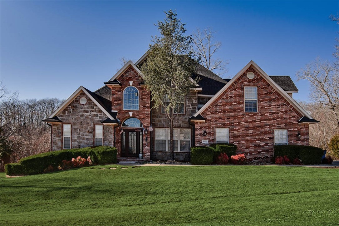 This stunning custom home sits on a private 2 acre lot in a sought-after neighborhood, just 6 miles from downtown Bentonville and the new Walmart home office and is just minutes from biking trails. Enjoy the tranquility of country living while being so close to all the amenities of town. Inside, the home features a a grand entrance, abundant natural light, soaring ceilings, and elegant railings, built-in cabinets, & a large formal dining area. The spacious, updated kitchen showcases a professional gas range, modern stainless vent hood, built-in refrigerator, microwave drawer & large built-in pantry with shelving. The updated primary suite has a private sitting room w/deck access, & a luxurious bath with tub, walk-in shower, & generous closet space. Two additional bedrooms & a large bonus room complete the 2nd floor. An expansive outdoor entertaining area with a huge deck & breathtaking views. Added bonuses include a whole-house water filtration system, and a tornado-rated closet under the stairs.
