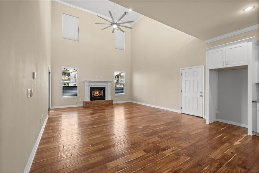 A showstopper! Elevated living meets effortless entertaining in this stunning corner-lot home in The Grove featuring high-end appliances throughout. From the moment you step inside, the soaring ceilings and dramatic open-to-above living room create a true “wow” experience - perfect for hosting and entertaining. The upstairs loft overlooks the main living space, adding a sense of luxury rarely found at this price point. The open-concept design flows seamlessly into a stylish kitchen with island seating, ideal for gatherings. A spacious main-level primary suite offers a private retreat, while upstairs bedrooms and flex space provide versatility.  Enjoy morning coffee on the cozy balcony or unwind on the patio below, surrounded by a generous yard. All of this in a location that’s incredibly hard to beat - just minutes from the Walmart AMP, Topgolf Rogers, premier shopping, dining, and trails.