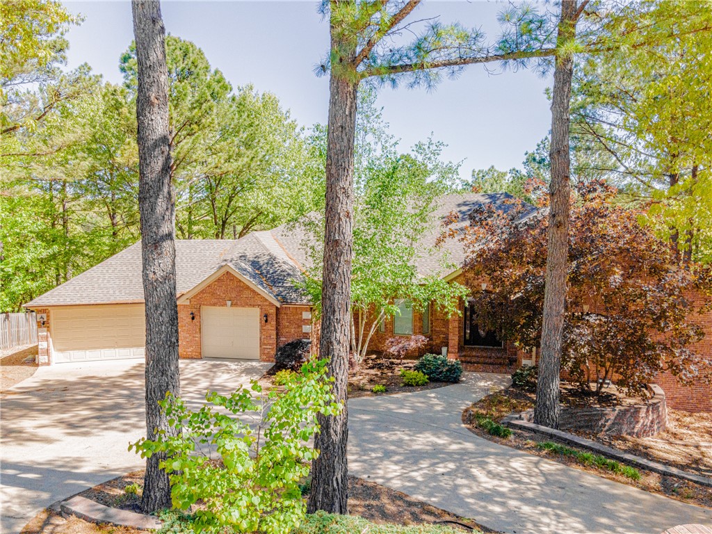 This magnificent two-story home is stunning! If you are looking for a home large enough for your family, or a home that is perfect for a Mother or Father-in-Law, then look no further. Situated on the 16th hole at Scotsdale, this golf front home has it all. It features not one, but two full kitchens. Complete with all appliances and granite countertops. If you need room in the garage for 4 or 5 cars, this has that as well. Screened porch to enjoy the outdoors bug free? Check! Large covered balcony deck, plus covered lower deck? Check! Formal Dining? Check! This is where impressive architecture meets mother nature. Nestled in the woods...yet stunning inside. This is one that you have to see for yourself...there is just too much here to describe. Listed as a 4 bedroom, but 3 bedroom septic. This home is also conveniently located near the Jane WalMart, other shopping and easy access to Bella Vista Way. This home is now priced at a point where you can renovate to your taste, best value/sf on the market. Sold as is.