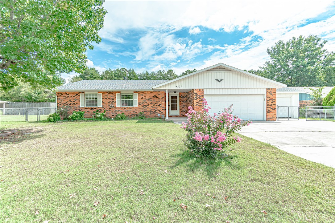 Classic brick home with spacious backyard! Living room features wood burning fireplace with a wood stove! Tile covers the kitchen with lots of counter space. Covered back patio with beautiful greenery in the backyard would be great for hosting!