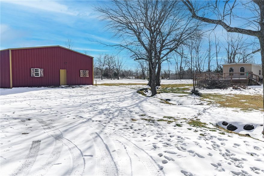 Discover an exceptional commercial/residential opportunity on 1.36 acres in Lincoln, Arkansas! This mixed-use property on W Holt Road features a large 40x60 shop building complete with a bathroom and office space—everything you need to start your business from day one. The property offers excellent infrastructure with public water, existing septic, and electric service already available. Situated on open, level terrain with three-side fencing, the land features a pond and wet weather creek adding natural beauty. Paved road frontage ensures convenient access, and there's a manufactured home on the property providing additional flexibility. Located in the Lincoln School District, this turnkey property combines peaceful rural surroundings with quick connectivity to Northwest Arkansas. Whether you're planning a contracting business, automotive shop, or storage facility, this property is ready for you to make it your own!