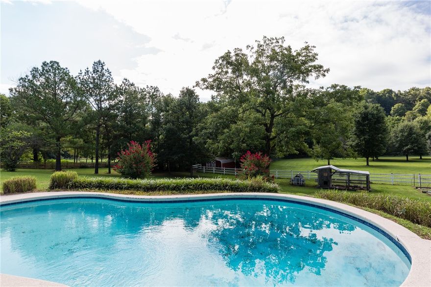 This could quite possibly be the most phenomenal property to hit the market in Fayetteville!  With almost 7 acres the views are exquisite.  If you need a shop, there is no better one than this one! It has 2400 sq.ft. of heated and cooled space, a security system, internet, and new paint. There is also a 3-car carport and a 2-car garage for plenty of parking and a 40x60 shop that has new doors and has been completely refurbished.  There is a spacious separate office that can be made into a 4th bedroom if needed.  This is a custom-built energy saving home and has 2x6 exterior walls with cellulose.  An upgraded Viking stove fit for a professional chef and newly refinished hardwood floors.  New roof was installed in 2020 and has a 10-year warranty.  Home has all new upgraded light fixtures on the inside and out. New white vinyl fence. Sitting out on the deck enjoying the views while your family and friends are swimming in the gunite, saltwater pool with a creek running behind the property will be magical.