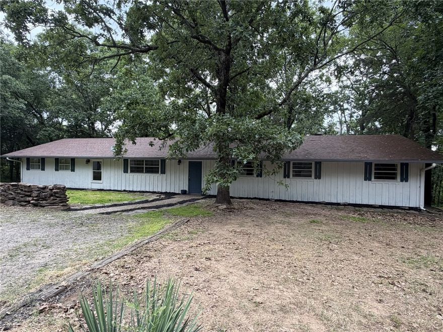 Nestled on 2.42 secluded acres, this spacious 4-bedroom, 3-bath home offers 2,648 square feet of comfortable living with room to grow! Featuring a desirable split floor plan, this home also offers the potential for an easy 5th bedroom conversion to fit your family’s needs. The oversized master bedroom is a true retreat with its own mini-split system for added comfort and efficiency. You’ll find wood laminate and ceramic tile flooring throughout, central heat and air, plus a cozy wood-burning stove. The large kitchen is perfect for entertaining and family gatherings, complete with brand-new double ovens installed in 2024. Outside, enjoy the peace and privacy of the wooded acreage along with plenty of storage and workspace options including a detached workshop with electricity and two additional storage buildings. If you’ve been looking for space, privacy, and versatility, this property checks all the boxes!