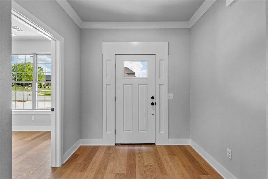 New Construction on a corner lot in an established neighborhood, so you won't be bothered with future construction noise! A beautifully designed 4-bedroom, 3-full bathroom home featuring a dedicated office space with a closet and an open-concept layout perfect for modern living. The spacious living room has a vaulted ceiling and is open to the kitchen. The kitchen is thoughtfully designed with quartz countertops and custom cabinets and includes a large walk-in pantry. The primary bathroom has dual sinks with linen storage, a walk-in shower, and a soaker tub. The primary suite also offers a luxurious walk-through closet that leads directly into the laundry room. The covered porch is perfect for entertaining or relaxing. Don’t miss your chance for new construction in Battlefield Estates near Baker Hayes Trail. 17 minutes to downtown Bentonville, 16 minutes to Walmart Campus, 15 minutes to downtown Rogers.