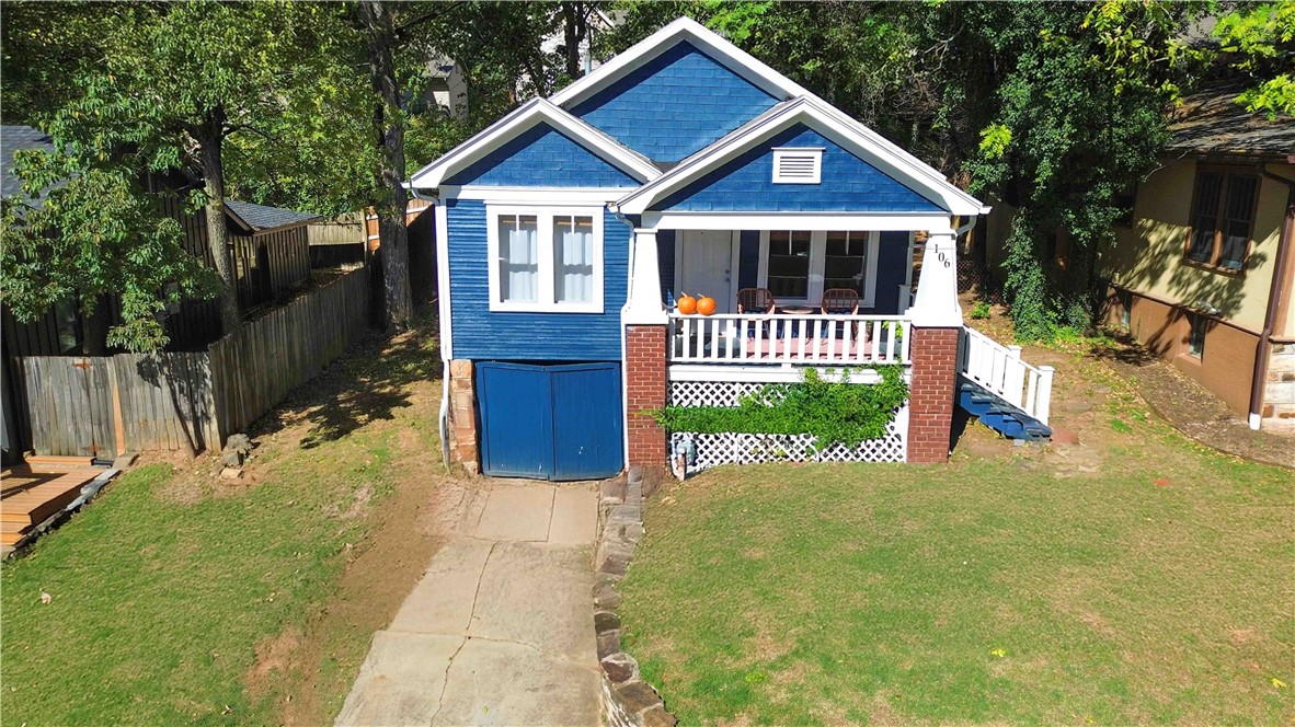 Discover charm and convenience in this adorable 2-bedroom, 1-bathroom home with brand new exterior paint. Perfectly situated just 1 block from Dickson Street and 3 blocks from the downtown square, and walking distance to shopping, dining, scenic walking trails, beautiful parks, and the University of Arkansas! Inside, you'll find hardwood floors throughout the main living areas, with stylish tile flooring in the kitchen and bathroom. Enjoy the abundance of natural light that fills the home, and relax or entertain on the inviting covered front porch. This cozy home blends comfort with an unbeatable location! House has new exterior paint.