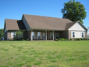 LUXURIOUS DWELLING AMDIST A ''PICTURE POSTCARD'' CATTLE AND HORSE RANCH. 3 ponds, improved pasture, cross-fenced. Steel, 5 wire fencing. Asphalt driveway leads to a 100'x 60' quanset, 80'x80' barn w/half bath, tackroom, stalls; 30'x50' metal shop w/half bath. NEW icemaker in kitchen.Brand new hardwood floors in home. Barn has its own septic tank. New storm cellar.