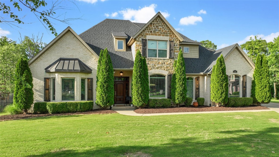 Welcome to luxury living in this stunning home nestled in the highly desirable Versailles subdivision! This modern residence boasts spacious living with an expansive, flat lot perfect for entertaining family and friends. Step inside to find 2 dining areas, large kitchen and living areas, a dedicated office, primary suite with spa-like bathroom, and 3 car garage, all downstairs. Upstairs, you'll find three bedrooms each with a full bathroom and the large entertainment room with a bar.
Enjoy relaxing evenings on your covered patio overlooking a beautifully landscaped backyard with private, heated in-ground pool. Outside of the fence, the property continues on to include a cozy fire pit with surrounding seating and tall trees for shade.
The Versailles community features quiet streets and a friendly neighborhood atmosphere, making it ideal for families and professionals alike. You’ll love the convenience of being just minutes from Bentonville West High School, Bike Trails and Bentonville’s vibrant downtown scene.