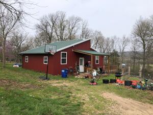 Neat 2BR cabin plus loft for 3rd BR on 20 acres adjacent to Huzzah Creek. House features include vaulted ceilings in living room and kitchen, laminate and wood floors, deck and view! Small pasture area with cross fencing. Land is mostly wooded with an outbuilding and has the potential for other cabin sites with views. Located 1.2 miles off Hwy 62/412 the property is convenient to town and many fishing, hiking, camping, and hunting venues! Within 45 minutes of Branson, Missouri, Bull Shoals and Table Rock Lakes, Buffalo and White Rivers! Check it out!