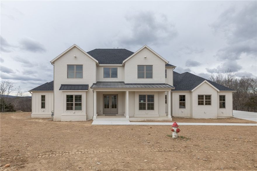 This striking 4-bedroom, 4.5-bath home in Asher’s Ranch showcases thoughtful design and custom details throughout, offering a refined yet comfortable living experience. Well-planned spaces reflect a modern, sophisticated aesthetic, highlighted by stainless steel appliances, quartz countertops, hardwood flooring, custom lighting, distinctive tile work, and abundant storage. The split floor plan features the primary suite on the main level along with a flexible space ideal for a home office or fourth bedroom. Upstairs, a spacious media room with a built-in wine fridge is complemented by two additional bedrooms, a study, and a sitting area—creating versatile spaces for both everyday living and entertaining. Outside, a covered concrete deck overlooks rolling hills and wooded views, providing a peaceful setting to unwind. This beautifully designed home is one you won’t want to miss.