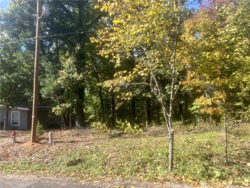 Build your vision on this 0.30-acre lot on Ulverston Dr in East Bella Vista. Featuring a gentle slope with a mix of level ground and mature trees, this property is ready for a custom home or smart investment. Paved road frontage and nearby utilities make it easy to get started.  Enjoy a prime location just minutes from Lake Ann, Back 40 Trails, and Metfield Golf Course, with quick access to I-49, Harps, and local shopping.