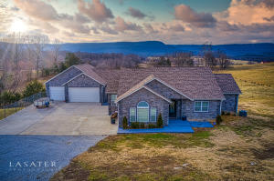 This is your home and 10 acres you've wanted right in the heart of the Ozarks. Lovely views of the evening sunsets across Gaither Mtn. awaits. This home has it all with potential to add more all. Main home (1728 sq ft) and guest house (454 sq ft) are new and modern with a covered breezeway joining them. Plumbing and unfinished sheetrock in basement allow for a future 5th bedroom and 4th bath. Beautiful white kitchen with accent cabinets painted that beautiful blue you've seen on Pinterest. Granite counters, stainless steel appliances, soft close cabinets, and pantry. Master suite has two walk-in closets and double vanity. Workbench in garage. The roof has solar fans installed for energy efficiency. The spring-fed pond is stocked with bass. The guest house includes a kitchenette space
