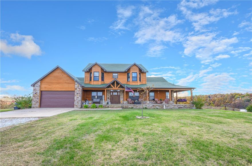 Experience peaceful country living on 18 stunning acres with beautiful views! This spacious 5-bedroom, 4.5-bath home features a gourmet kitchen with custom cabinetry, a stone wood-burning fireplace, and soaring cathedral ceilings. The open living area includes a wet bar—perfect for entertaining or relaxing evenings at home. The finished basement offers plenty of additional living space, ideal for a media room, game room, or guest suite. Roof was replaced 12/24. Enjoy the tranquility of nature all around you while still being a short drive to Gravette and Bentonville amenities. This one-of-a-kind property combines comfort, elegance, and privacy in a breathtaking setting.