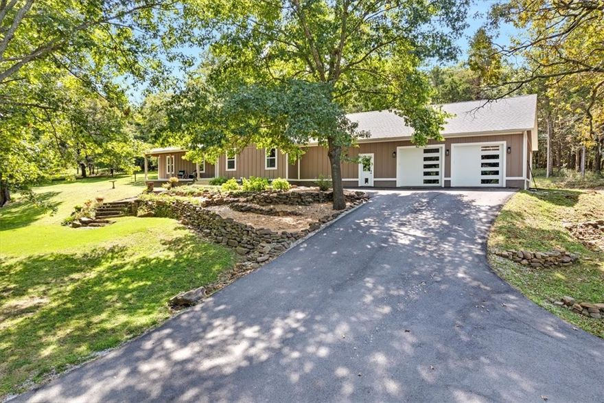 Generational opportunity to own 10.6 acres in the heart of Goshen, AR. This four bed, three bath home was recently updated. Inside you'll find new picture windows capturing the surrounding natural beauty. Enjoy the views from your large kitchen island and stay warm with the handsome wood stove. The covered front porch is perfect for morning coffee. Approx. six of the acres are grassy with shade trees spread throughout. The remaining four acres are timber and home to deer and turkey (rare to find acreage this beautiful so close to town at this price). New roof, floor, & A/C in 2020. Property features a 100 year-old barn with electricity. Three car garage with workbench. Bonus space in garage with climbing wall currently used as an exercise room. Extensive asphalt driveway installed 2022. Invisible fence installed. Walk to the Goshen Community Center to enjoy fresh produce sold at the Goshen Farmers Market. Pancho's restaurant steps away and Orthodox Brewery only 1.5 miles down the road. Fayetteville School District.