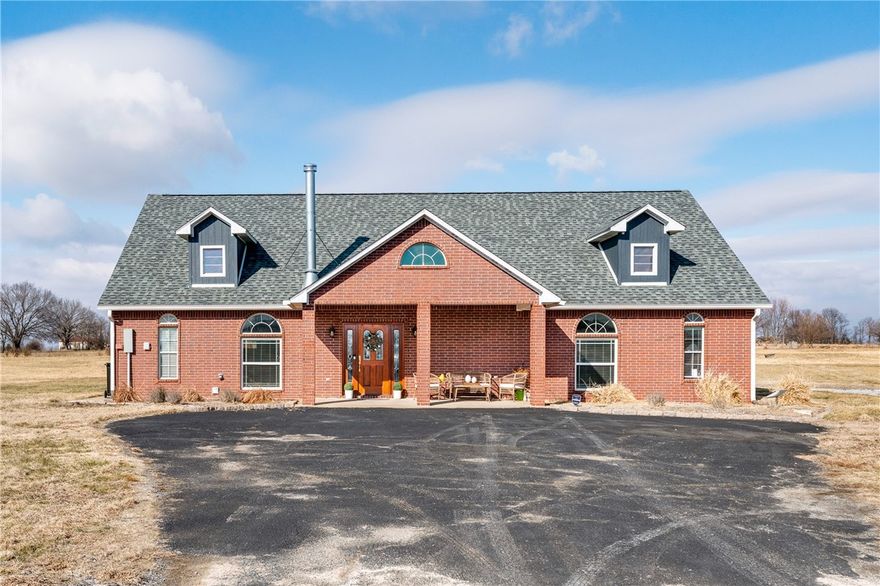 Set on nearly 9 acres of scenic land, this thoughtfully designed home offers a rare blend of privacy, space, and versatility. Designed for both everyday living and elevated entertaining, the home features a functional kitchen that opens to the dining and living areas, creating a comfortable and practical layout well suited for family life and gatherings. Three generously sized bedrooms and two full baths provide comfort and privacy, while an open upper-level retreat offers flexibility as a private office, reading lounge, media room or creative studio. Expansive windows and open sightlines connect the interior to the surrounding natural beauty, with recent updates including roof, driveway & underground electric and nearly nine acres of land providing room for outdoor living, future enhancements or peaceful retreat. Enjoy the peace of open skies with easy access to schools, shopping, dining, and everyday conveniences—a true blend of rural charm and everyday accessibility.