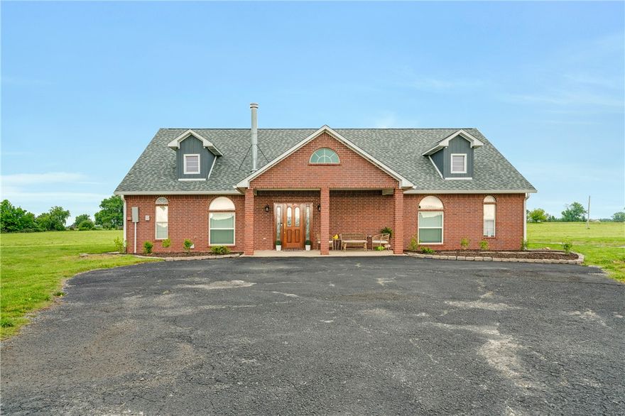 Set on nearly 9 acres of scenic land, this thoughtfully designed home offers a rare blend of privacy, space, and versatility. Designed for both everyday living and elevated entertaining, the home features a functional kitchen that opens to the dining and living areas, creating a comfortable and practical layout well suited for family life and gatherings. Three generously sized bedrooms and two full baths provide comfort and privacy, while an open upper-level retreat offers flexibility as a private office, reading lounge, media room or creative studio. Expansive windows and open sightlines connect the interior to the surrounding natural beauty, with recent updates including roof, driveway & underground electric and nearly nine acres of land providing room for outdoor living, future enhancements or peaceful retreat. Enjoy the peace of open skies with easy access to schools, shopping, dining, and everyday conveniences—a true blend of rural charm and everyday accessibility.