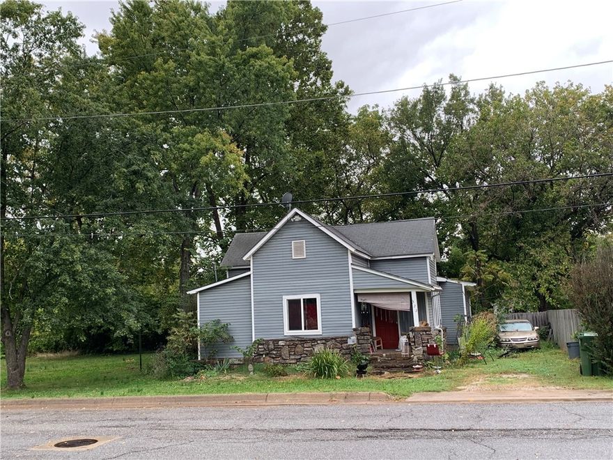 Zoned Multi-Family. Huge price reduction.  Properties include the following addresses (2.73 acres):  612 W Persimmon (1.87 ac), 410 N 6th Street (.30 ac), 322 N 6th Street (.35 ac), 620 W Persimmon St (.21 ac). Public water and sewer at the street. House being sold "as is" with no termite policy. Currently it is getting appr $950/mo in rent. Beautiful mature trees and great development potential. No retention pond needed for drainage so all land is usable. This area is booming with new developments and very close to downtown Rogers.