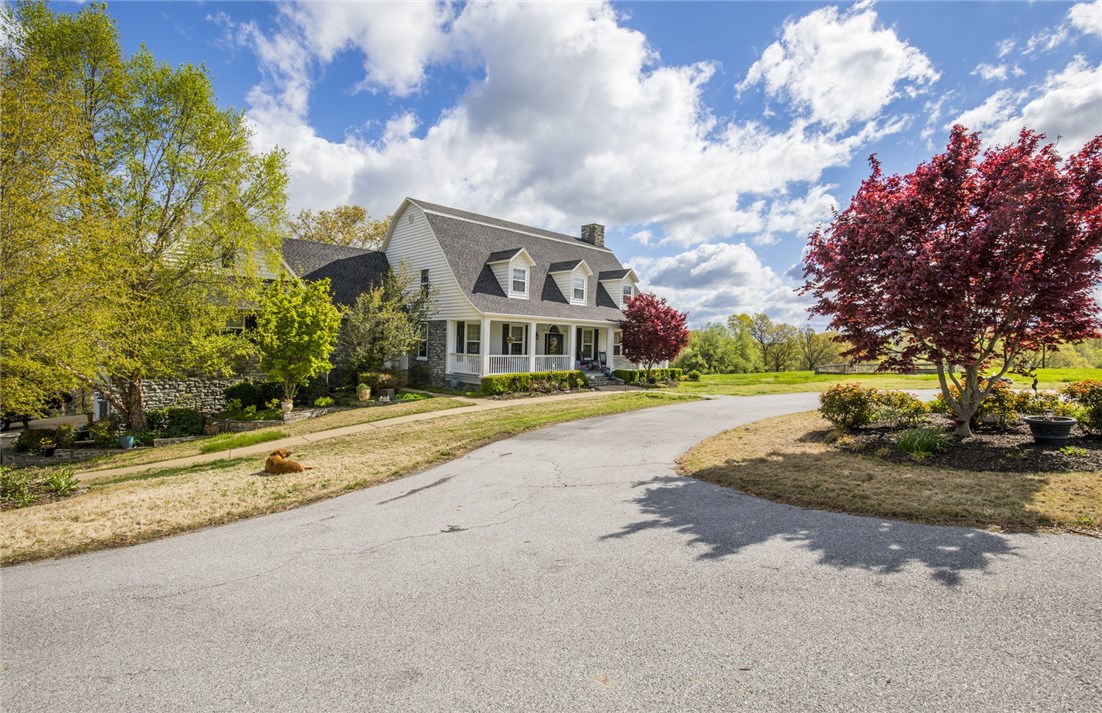 Stunning country estate on 9.61 acres in Bentonville school district. This 8015 sq ft. 5 BR-5.5BA custom-built home offers everything you’ve ever wanted. Featuring private ensuite baths in 4 bedrooms, open floor plan, wood beams, farmhouse character abounds! Basement level walks out to in-ground saltwater pool with gorgeous views of the countryside and is equipped with living and recreation areas, bunk room, full bath, kitchen, exercise room, craft room, and tons of storage- perfect for an in-law suite or AIRBNB. Home has been freshly painted and wood floors were recently refinished.