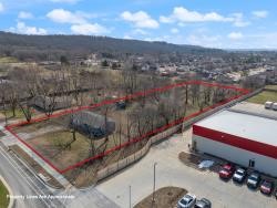 Please refer to MLS: 1298936. The property at 1303 Kendrick Avenue in Springdale, Arkansas, offers a 1.89-acre lot situated in a prime industrial park, ideal for constructing a city-approved commercial building. With approximately 124 feet of street frontage and a depth of 617 feet, it provides ample space for various commercial ventures. Notably, Kendrick Avenue is being expanded into a three-lane road to support ongoing development and will connect to Old Missouri Road, enhancing accessibility. This is priced with no value given to any structure or house