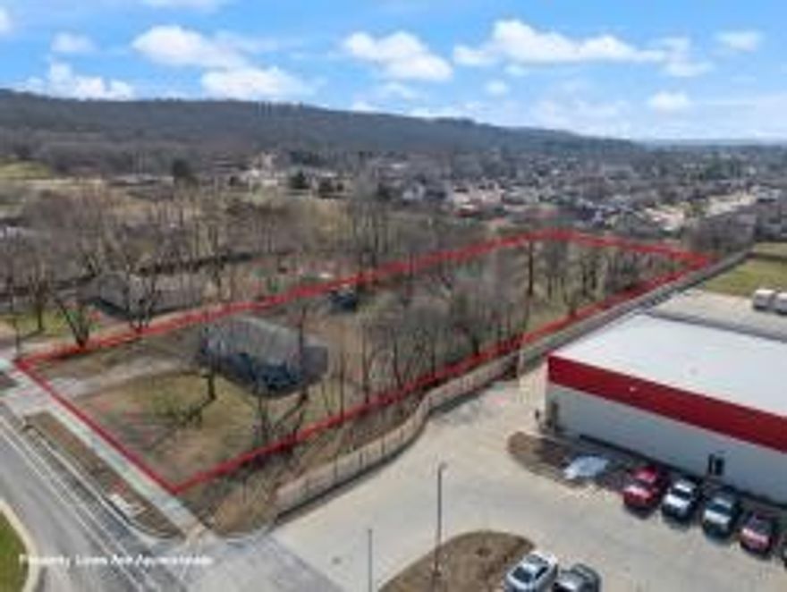 Please refer to MLS: 1298936. The property at 1303 Kendrick Avenue in Springdale, Arkansas, offers a 1.89-acre lot situated in a prime industrial park, ideal for constructing a city-approved commercial building. With approximately 124 feet of street frontage and a depth of 617 feet, it provides ample space for various commercial ventures. Notably, Kendrick Avenue is being expanded into a three-lane road to support ongoing development and will connect to Old Missouri Road, enhancing accessibility. This is priced with no value given to any structure or house